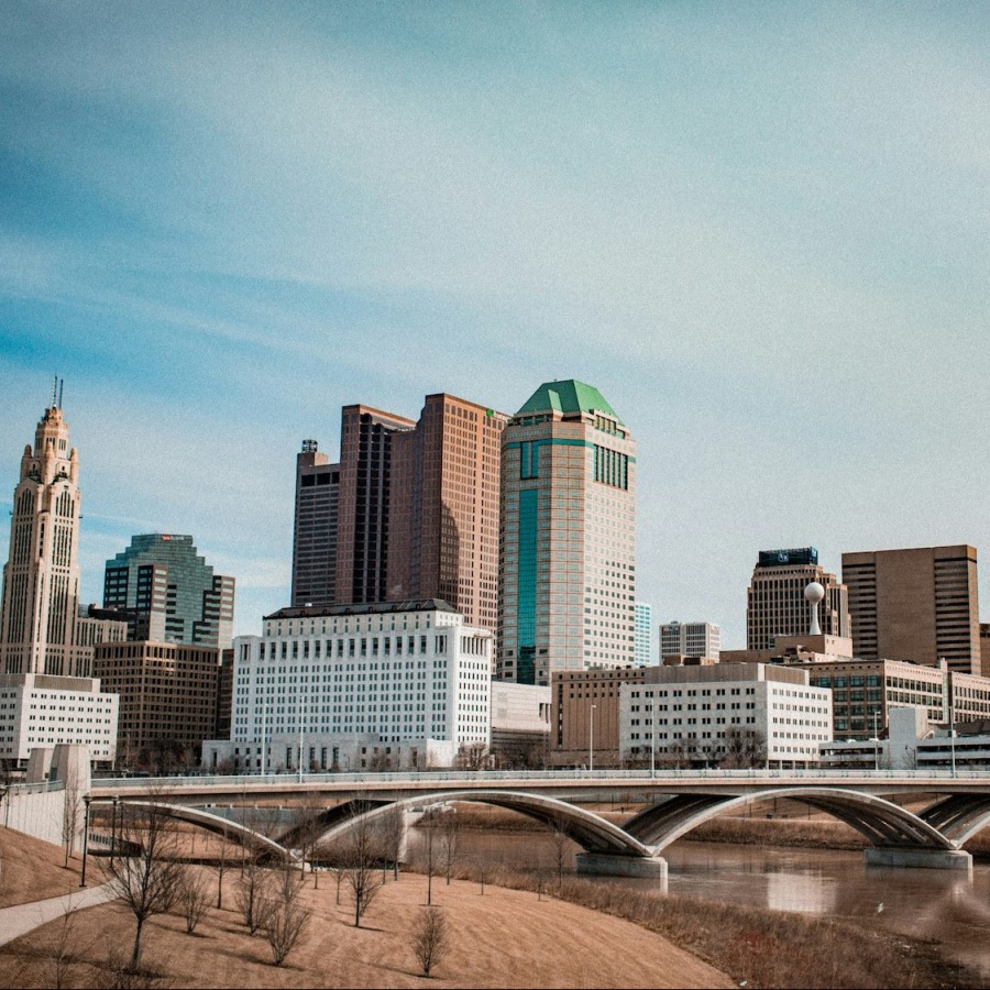 a skyline with skyscrapers and a bridge