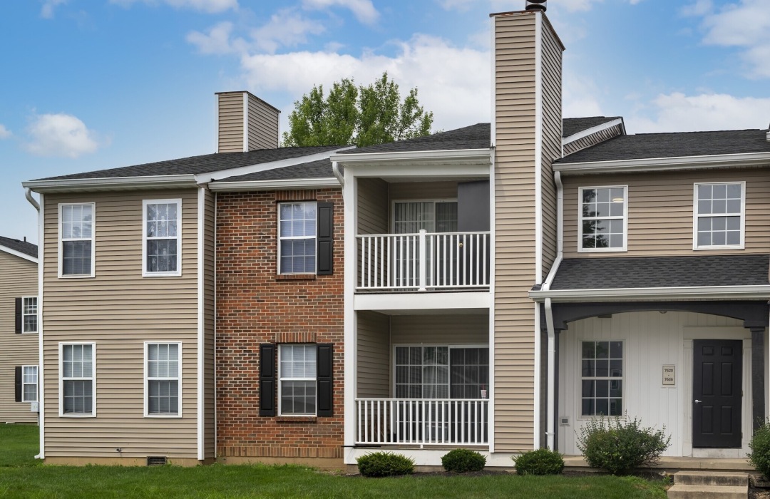 an apartment building with grass