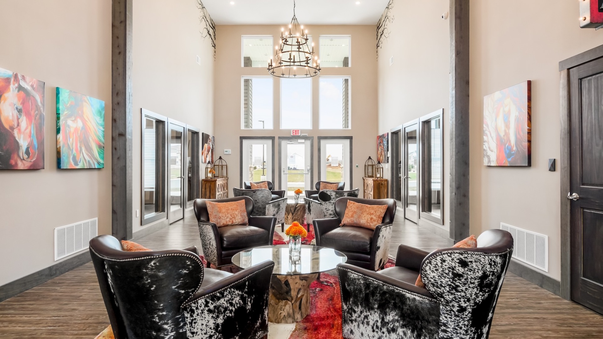a lounge with seating tables and a chandelier
